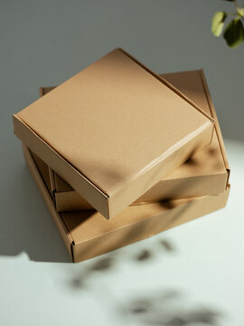 Stack of cardboard boxes with natural light and shadows