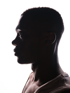 Young black man in profile silhouette thinking