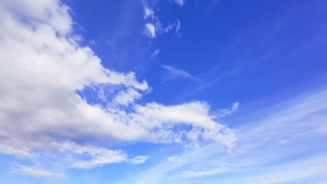 Beautiful sky captured in timelapse, showcasing dynamic movement of clouds across a bright blue background.
