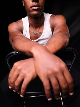 Black man showing Impossible tattoo on chest