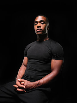 Black man posing in studio with serious expression