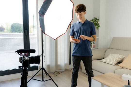 Content creator use smartphone in home video studio