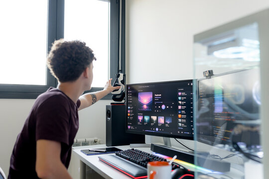Young man use AI tools at dual monitor computer