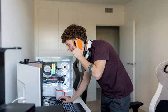 Young man using AI tools at gaming computer