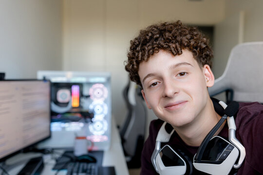 Young man with headset at gaming computer workspace
