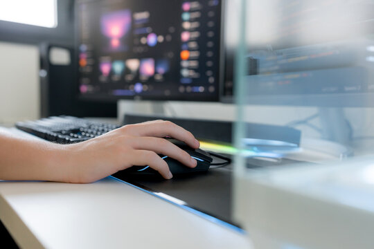 Young man use AI tools on gaming computer at desk