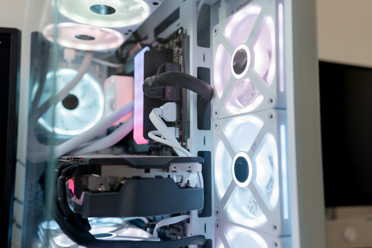 White gaming computer with RGB cooling fans and graphics card