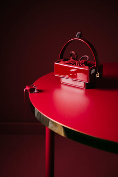 Red Patent Handbag on Minimal Red Table