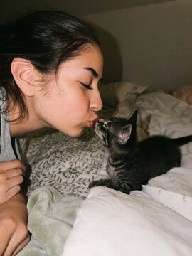 Girl Kissing her Kitten