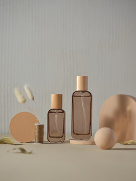 Two perfume bottles stand gracefully with wooden caps