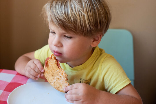 Boy eating homemade pizza