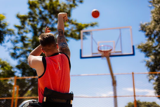 Wheelchair Basketball Player Shooting Basket Outdoors