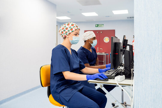 Medical professionals working at computer workstation in hospital