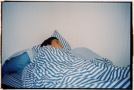 Stripped Sheets Sleeping Boy Bed