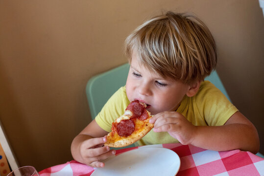 Boy eating homamade pizza at home