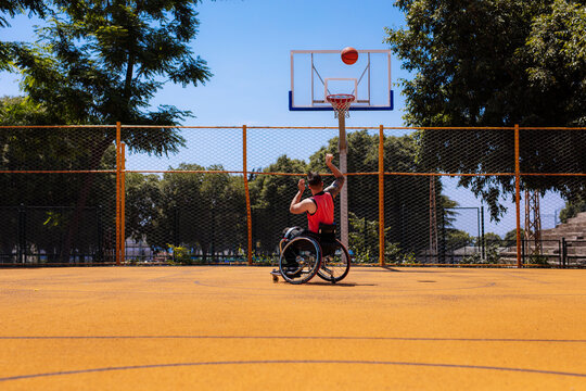 Wheelchair Basketball Player Shooting On Outdoor Court