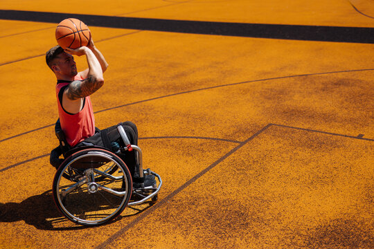 Wheelchair Basketball Athlete Shooting on Outdoor Court