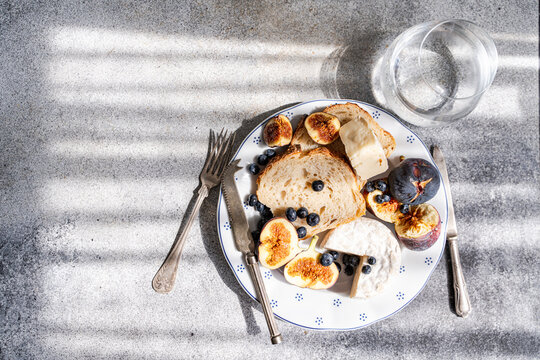 Fig and brie cheese breakfast with blueberry and bread