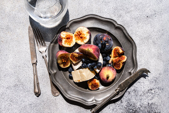 Fig and brie cheese plate with blueberry and water