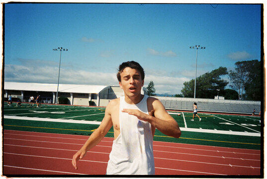 Runner Trains on Track Sports Field