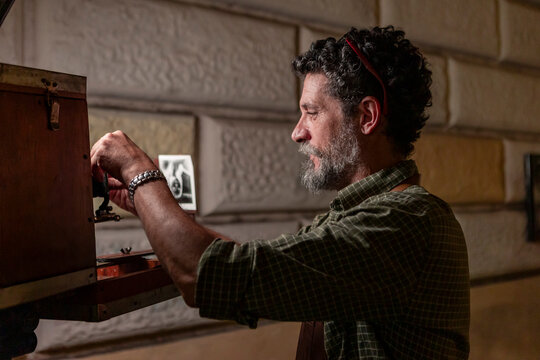 Photographer preparing a vintage analog camera for a portrait