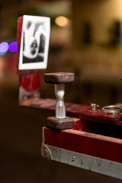 Vintage hourglass on analog photography display stand