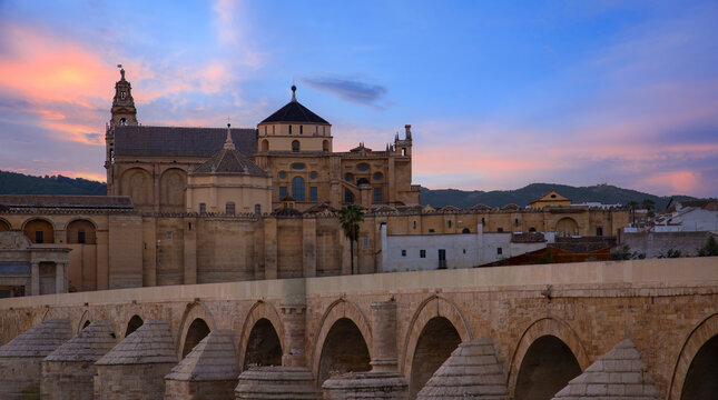 Roman Bridge and Mezquita Cathedral in Cordoba at sunset