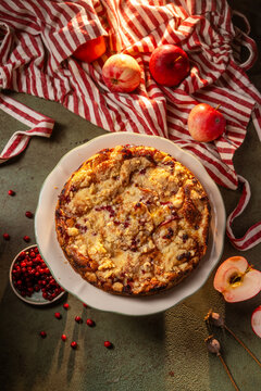Homemade apple crumble pie with cranberry and autumn fruit