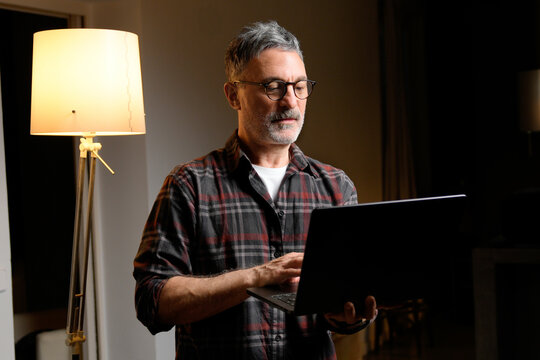 Mature man use laptop for remote work at home