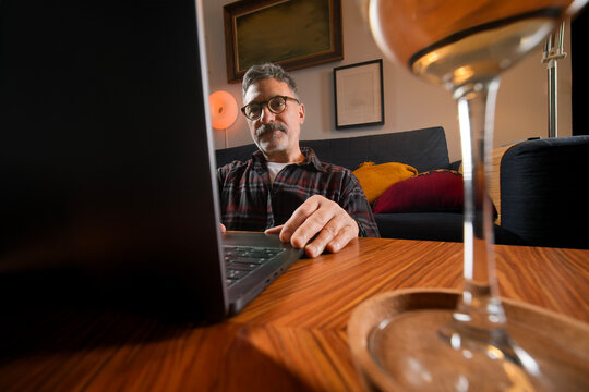 Mature man use laptop for remote work at home