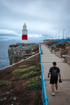 Tourist walking toward Europa Point lighthouse in Gibraltar