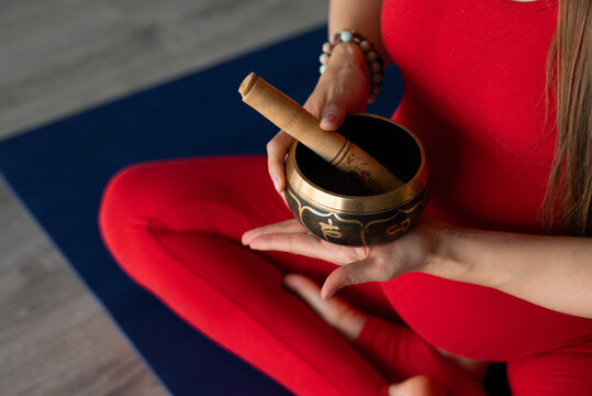 Pregnant woman practice yoga with Tibetan singing bowl