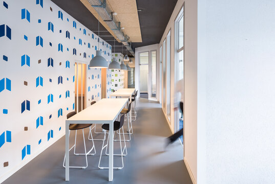 Modern coworking office corridor with shared work tables
