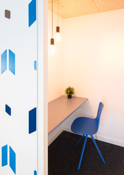 Modern coworking office with blue chair and workspace