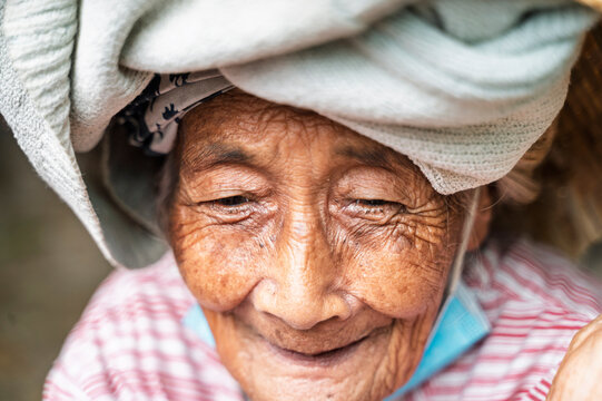 Smiling elderly Balinese woman wearing a cloth headwrap