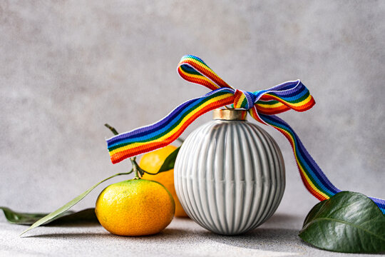 Christmas ornament with rainbow ribbon and fresh orange