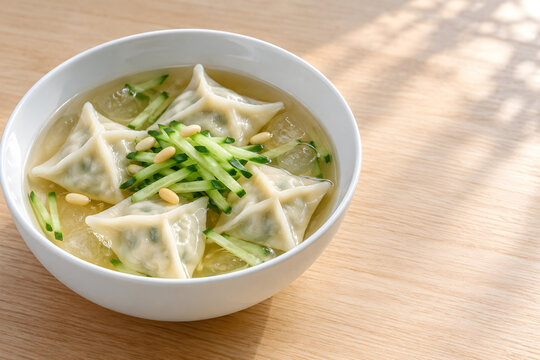 Korean pyeonsu square dumplings in chilled clear broth