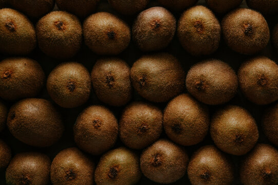 Close-up of ripe kiwi fruit pattern in low-key light