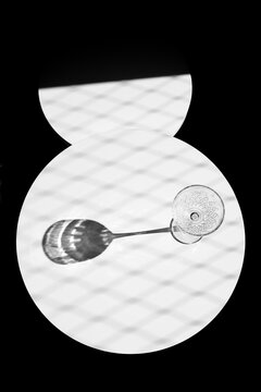 Empty cocktail glass cast shadow on patterned surface