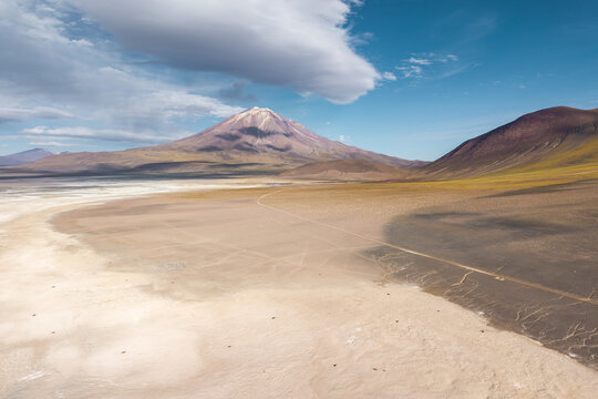 Altiplano landscape with volcanic peak and salt flat