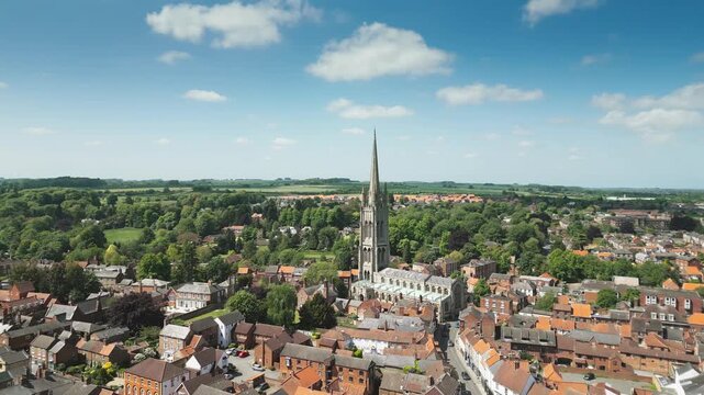 Aerial view of historic town with cathedral spire rising above rooftops