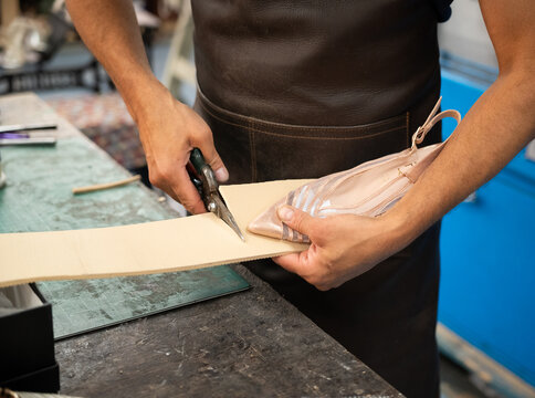 Shoemaker cut leather sole pattern in footwear workshop