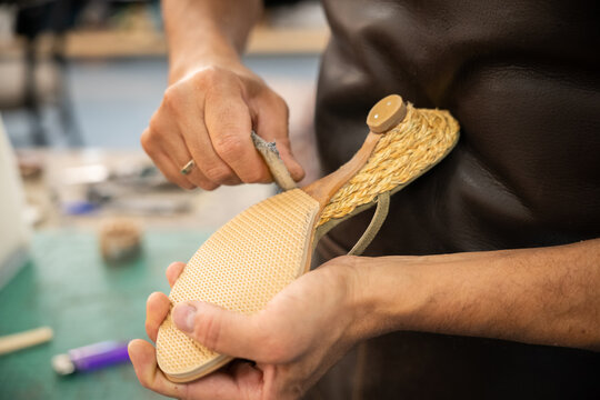 Artisan repair shoe in traditional footwear workshop
