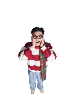 Astonished Boy with Glasses: A young boy with thick-rimmed glasses and a striped sweater shows an expression of pure shock and disbelief, hands pressed to his cheeks.