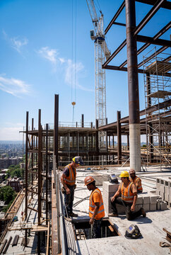 Construction worker on high-rise building site with crane