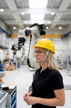 Female engineer in hard hat inspect factory equipment