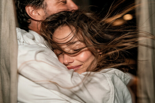 Loving couple embrace in windblown intimate portrait