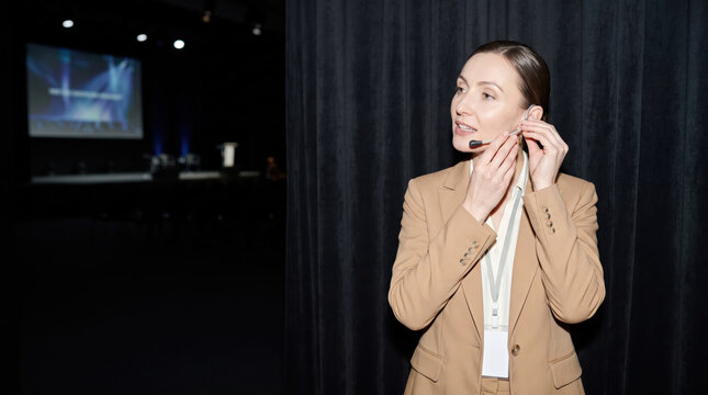 Speaker fitting a slim headset microphone backstage