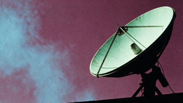 Satellite dish antenna on rooftop against dramatic sky