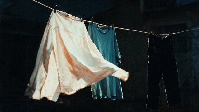 Laundry drying on clothesline in warm sunlight at home